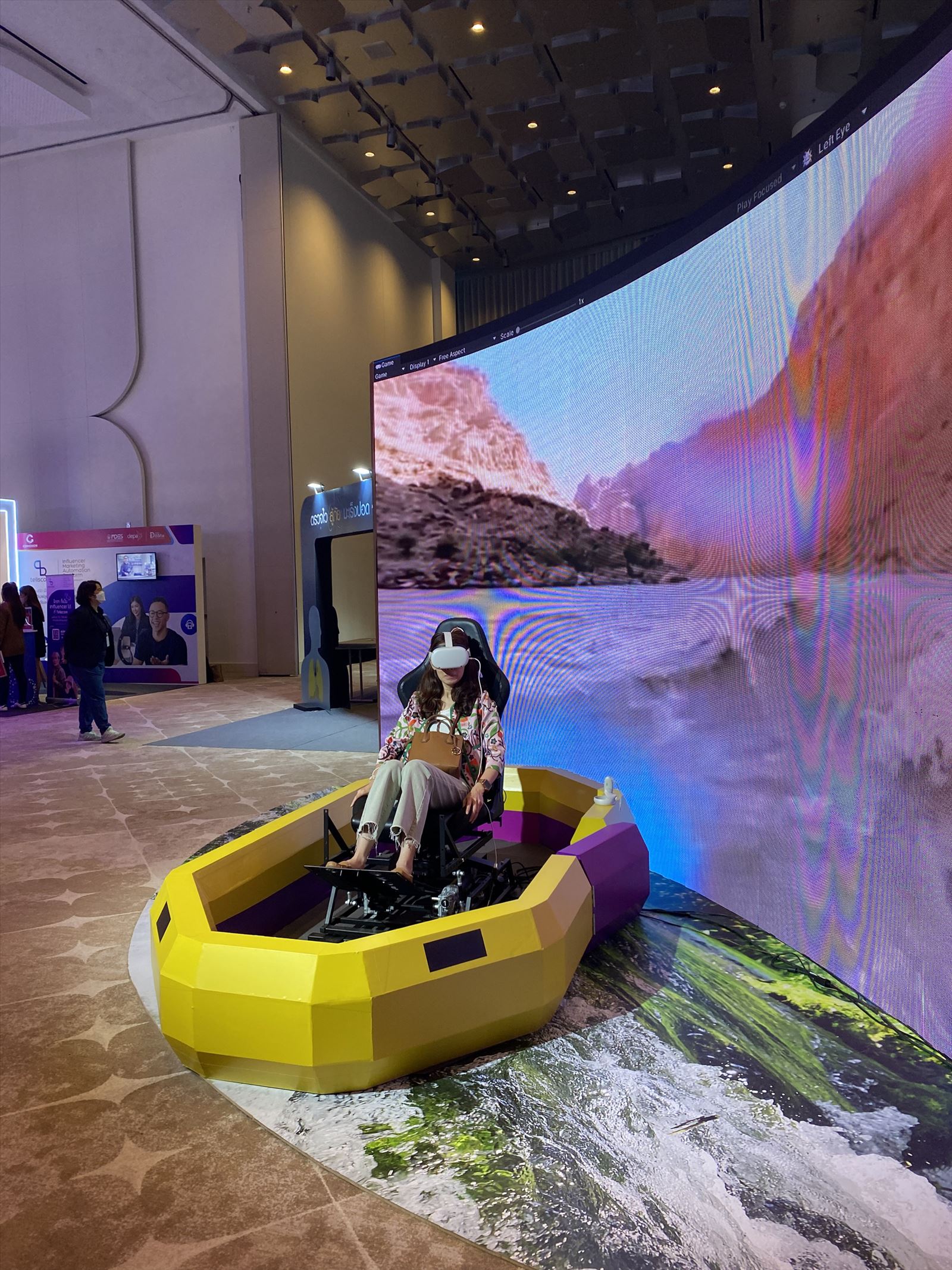 A rider in a VR headset on a motion platform simulator